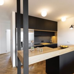 Lights in black kitchen interior with bright modern countertop a