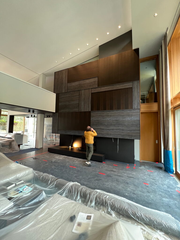 Bespoke oak wall cladding and custom fireplace during the installation phase